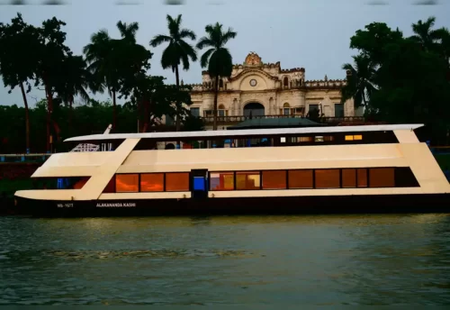 A cruise boat on the Ganga in Varanasi with the ghats behind