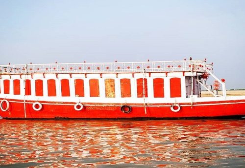 A large red and white Bajra boat on the Ganga in Varanasi