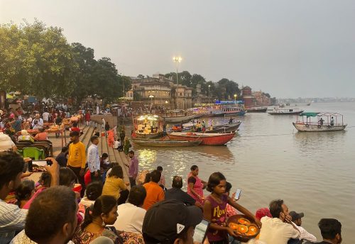Visitors on the steps of Assi Ghat at dusk