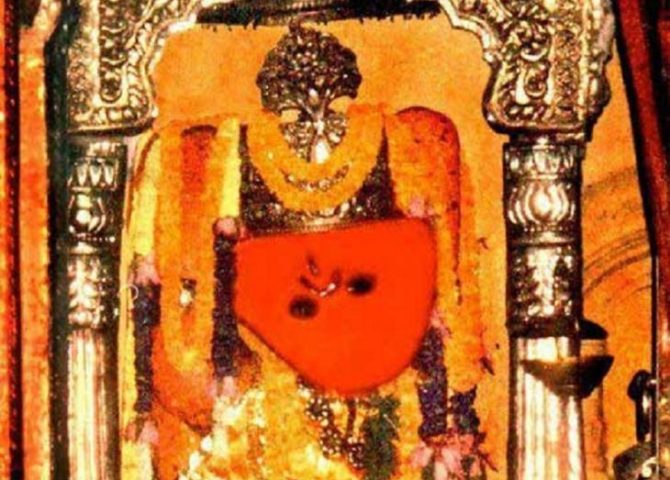 Sankat Mochan Hanuman decorated with flowers and silver ornamentation
