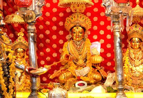 Annapurna Devi seated with a golden vessel and ladle