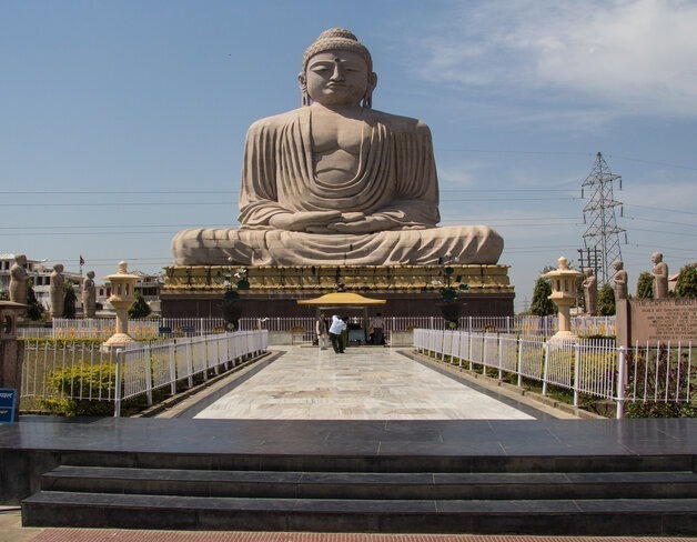 The 80-foot Great Buddha statue at Bodh Gaya seated in meditation, viewed from the garden path