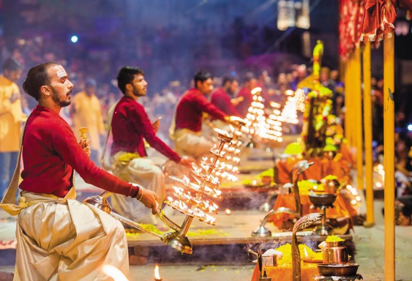 Priests performing the evening Ganga Aarti beside the river