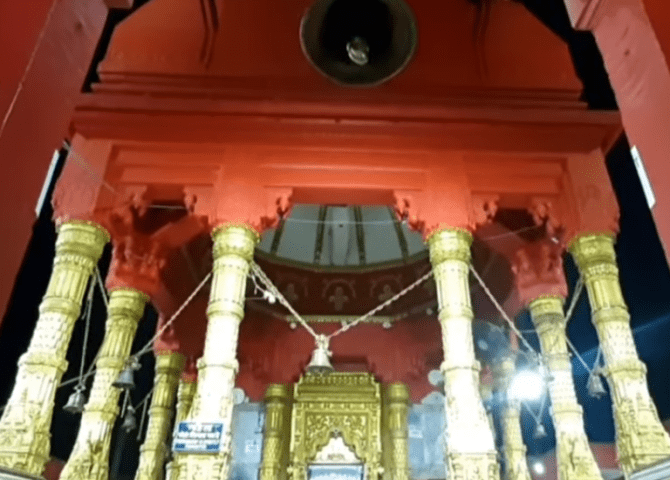 The richly decorated inner shrine with gold-toned pillars at Durga Temple
