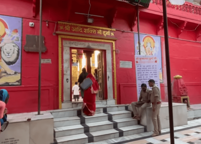 Visitors approaching the red inner shrine at Durga Temple in Varanasi