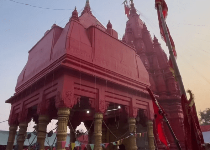 The red Nagara-style shikharas and pillared entrance of Durga Temple