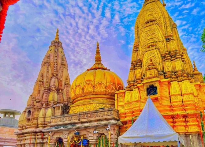 Devotees queuing beside the golden spires of Kashi Vishwanath Temple