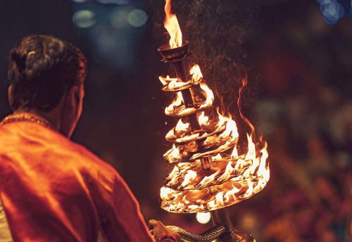 A priest holding a lamp during the evening Ganga Aarti at Assi Ghat