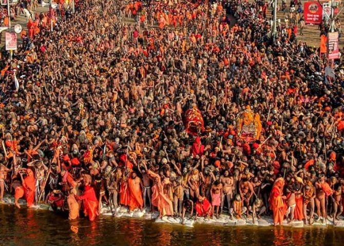 Pilgrims bathing at the Triveni Sangam during the Kumbh Mela in Prayagraj