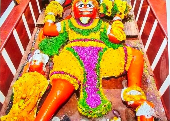 The reclining Hanuman idol at the Lete Hanuman Mandir in Prayagraj, decorated with flowers