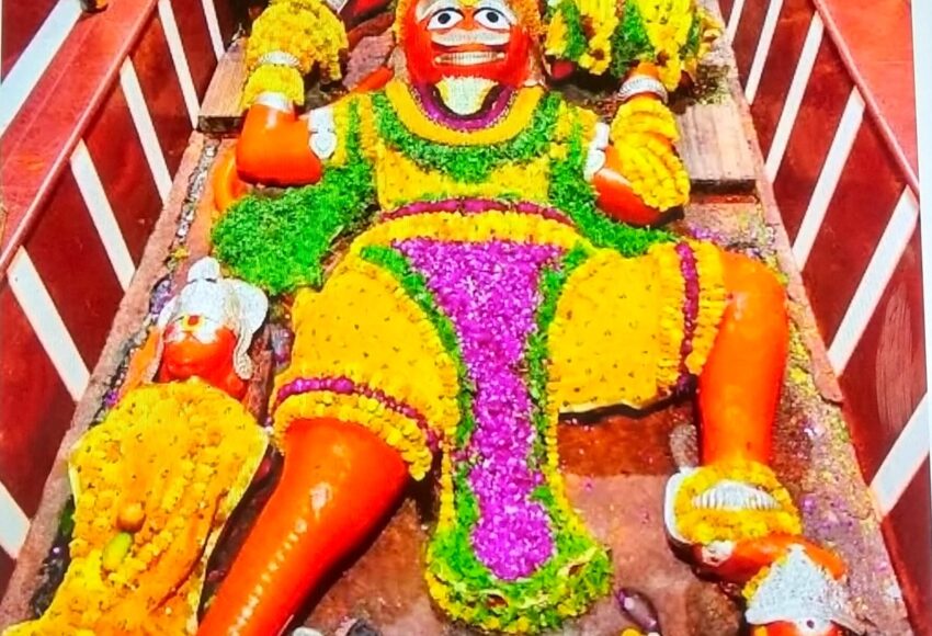 The reclining Hanuman idol at the Lete Hanuman Mandir in Prayagraj, decorated with flowers