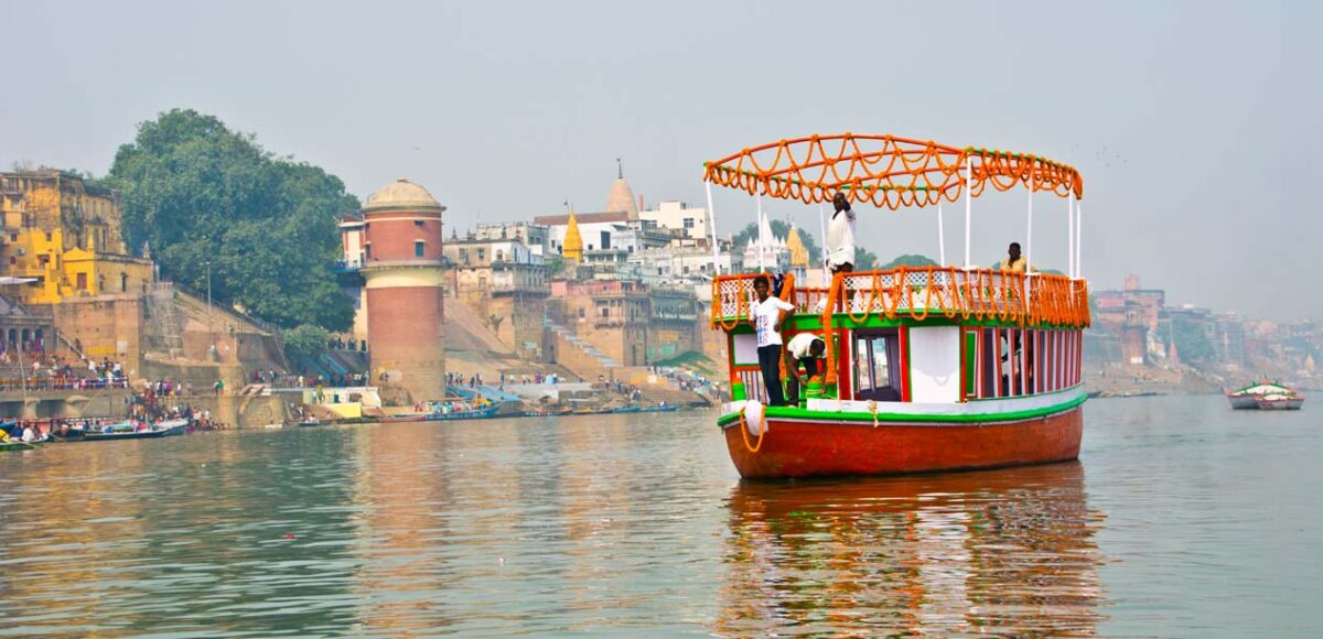 A decorated boat on the Ganga along the ghats of Varanasi